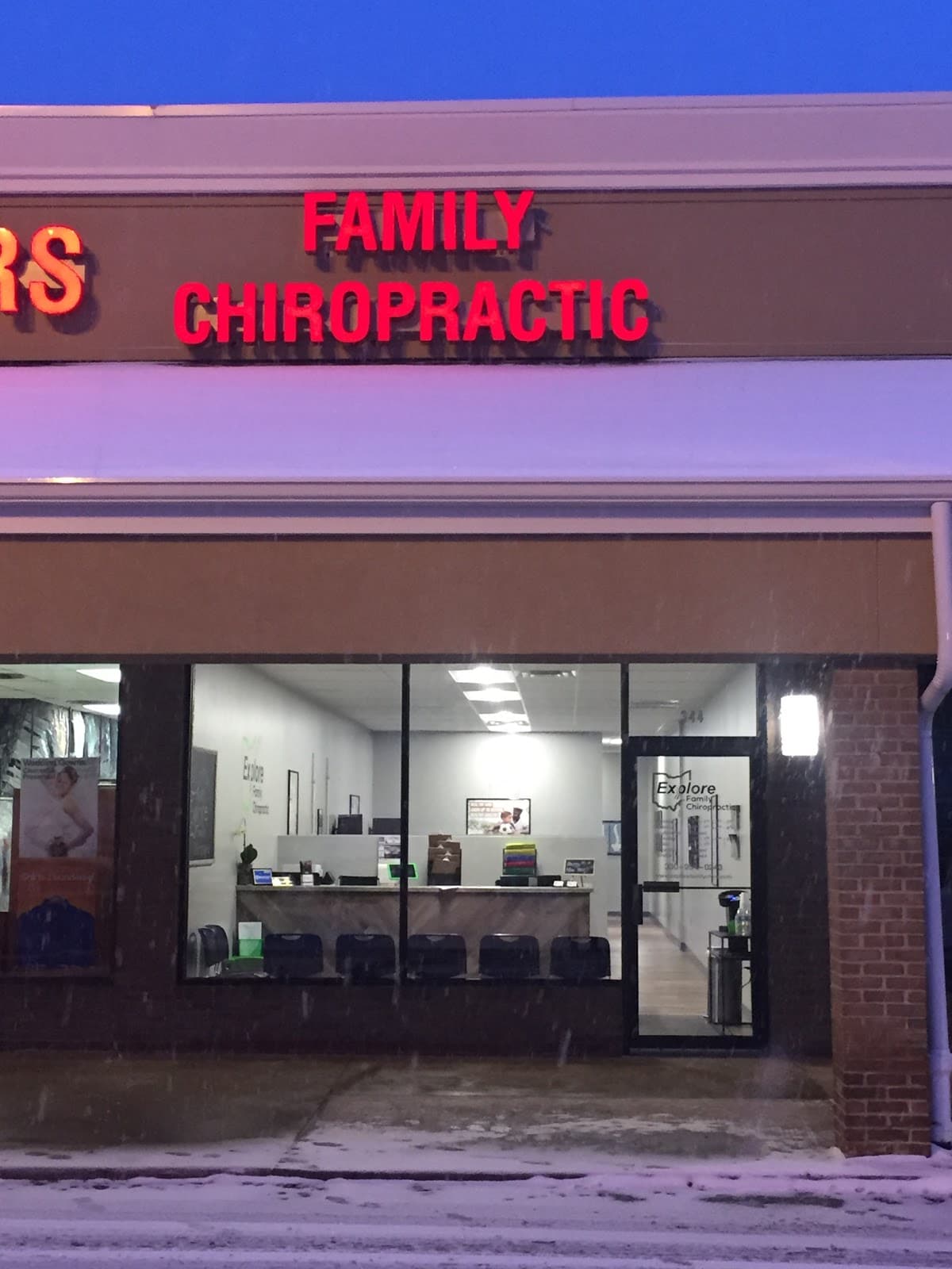 The Explore Family Chiropractic storefront in Aurora, Ohio at dusk
