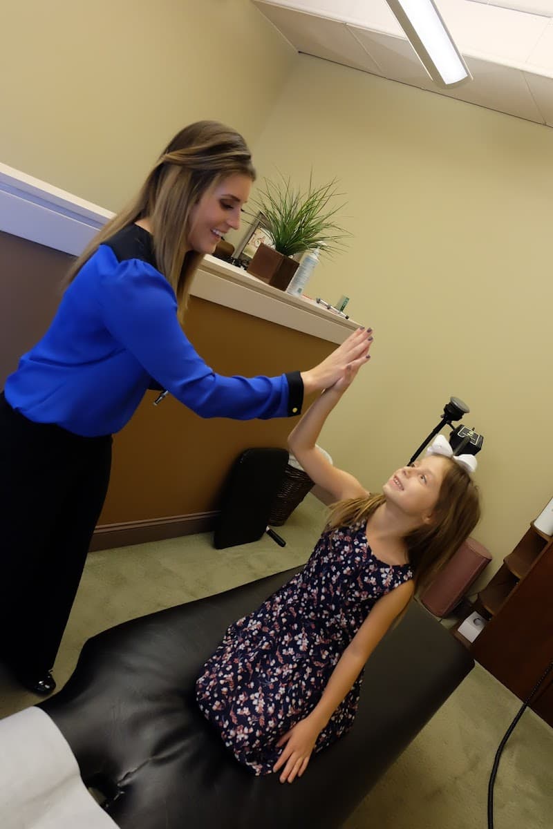 A young patient gets a high five during a gentle pediatric visit at Explore Family Chiropractic in Aurora, Ohio